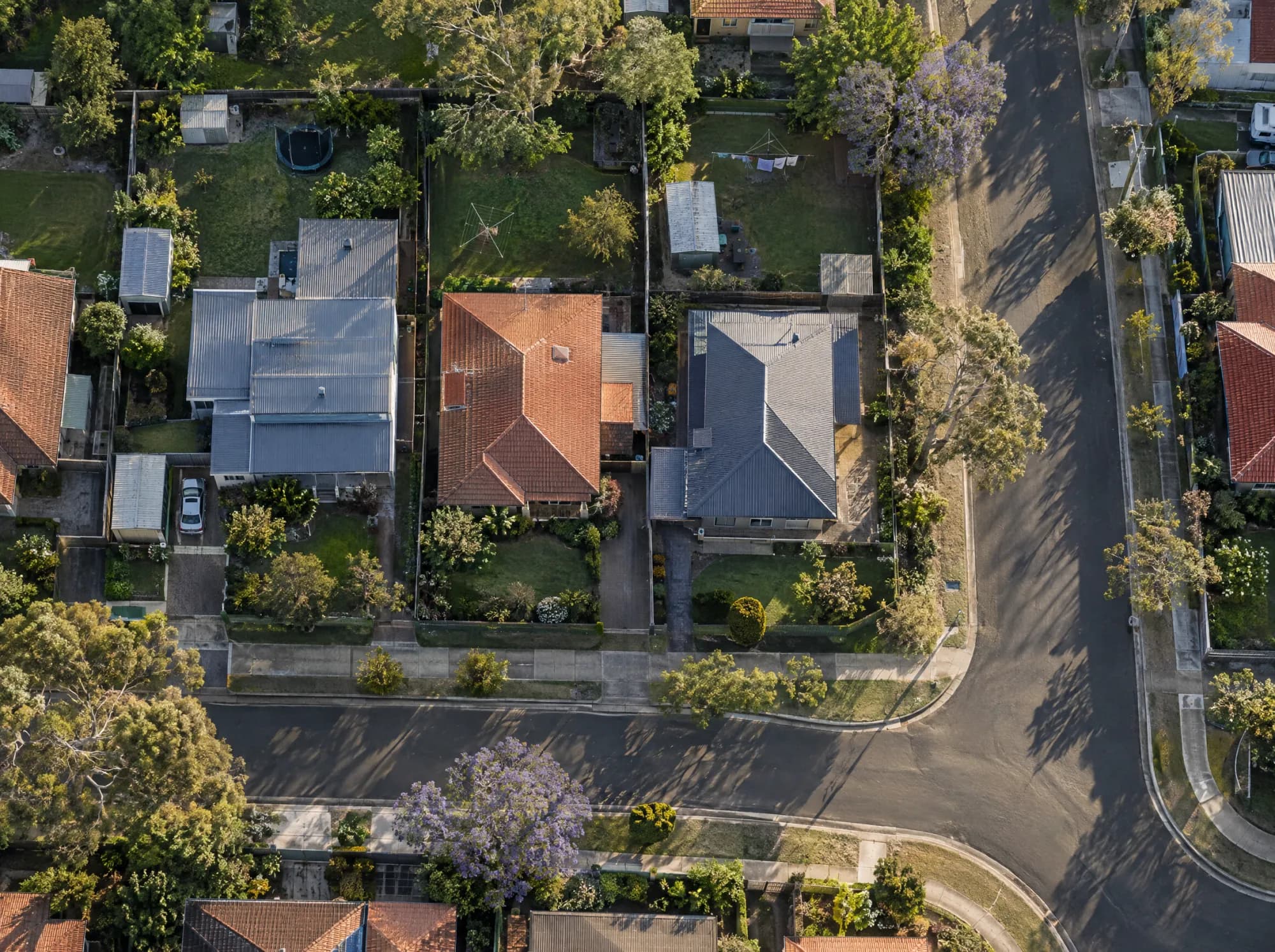 Aerial view of an Australian suburban street with one house block outlined