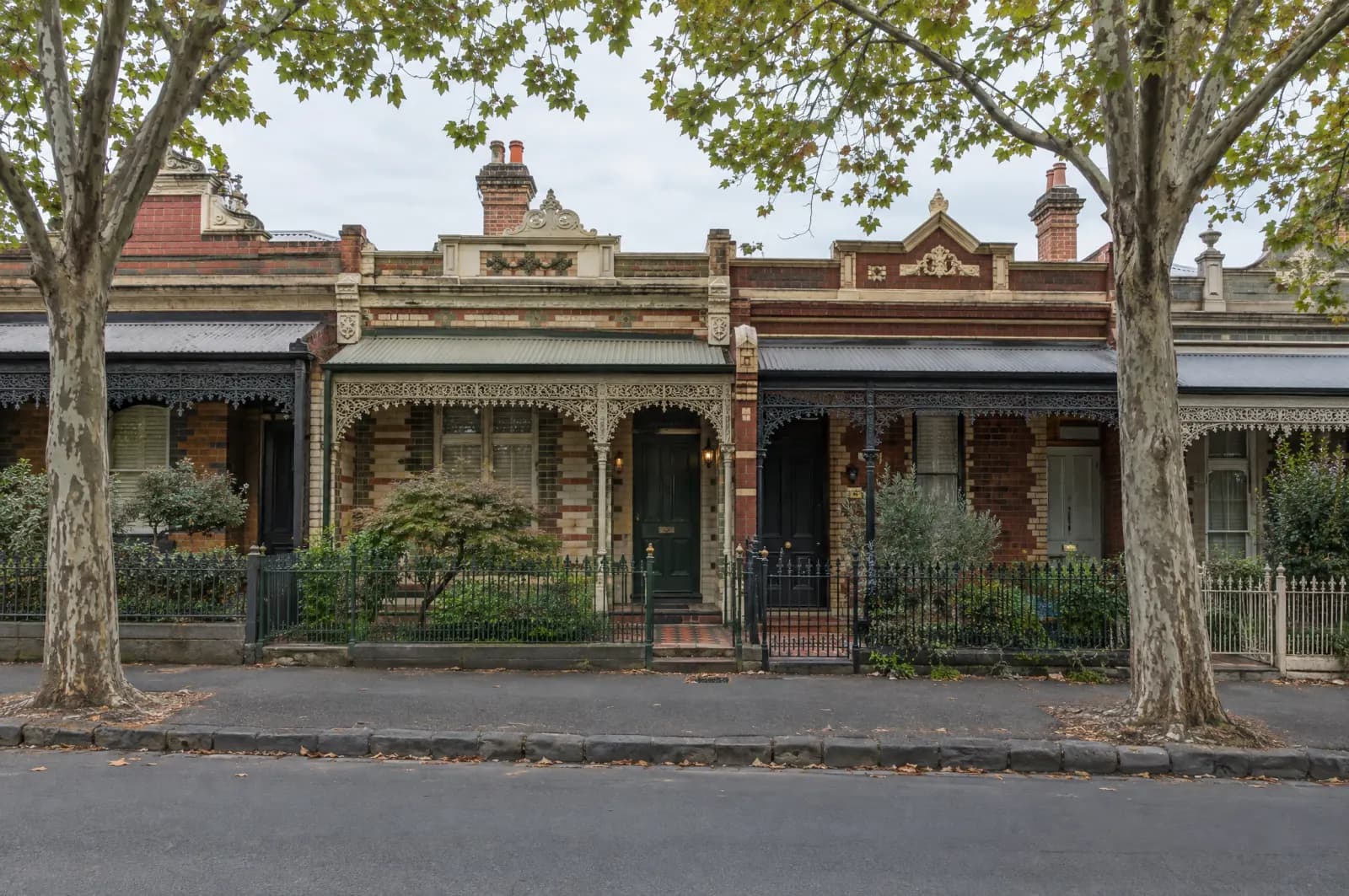 A row of Victorian terraces with cast-iron lace verandahs in Melbourne